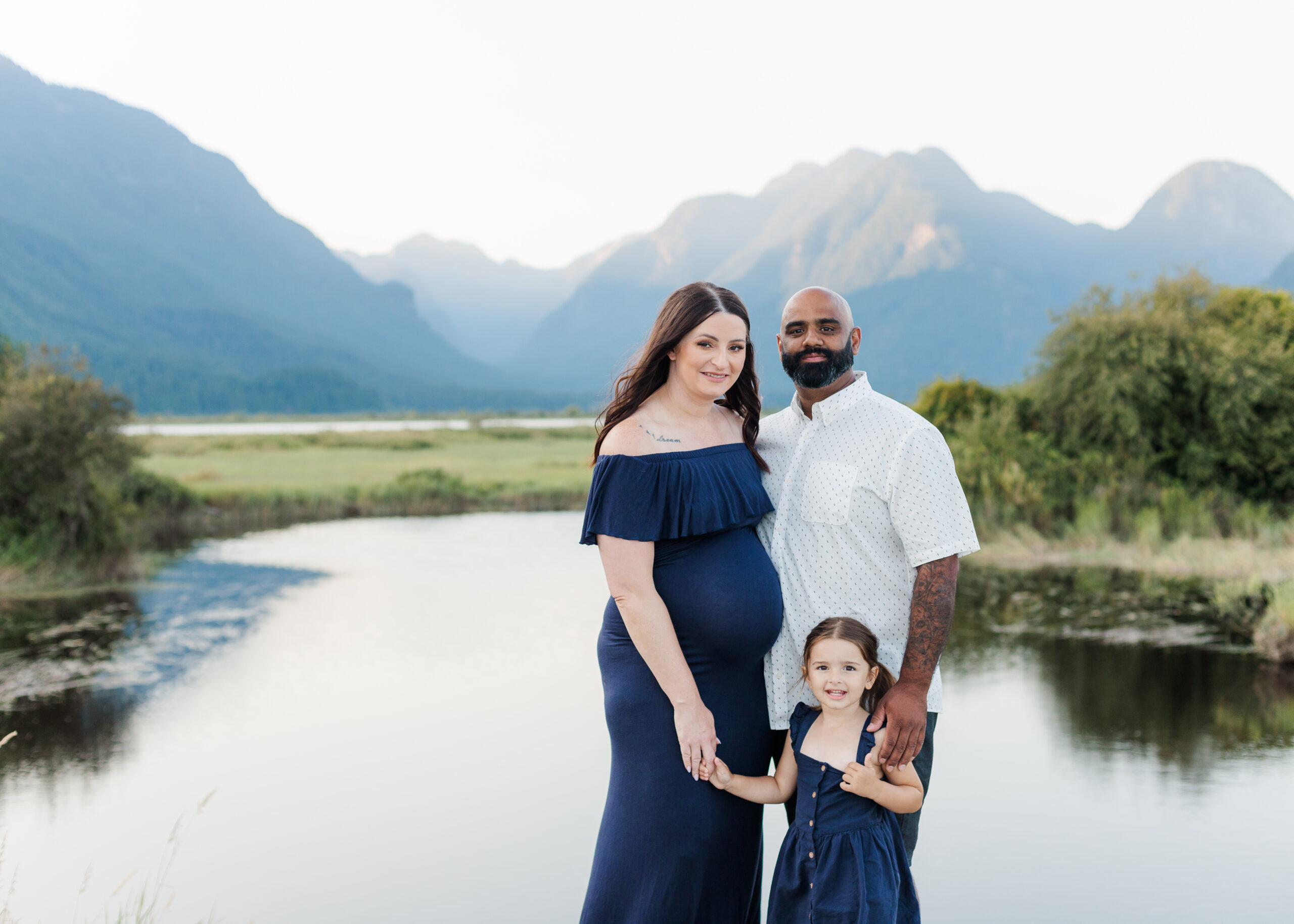 maternity photos with mountains and lake as a backdrop