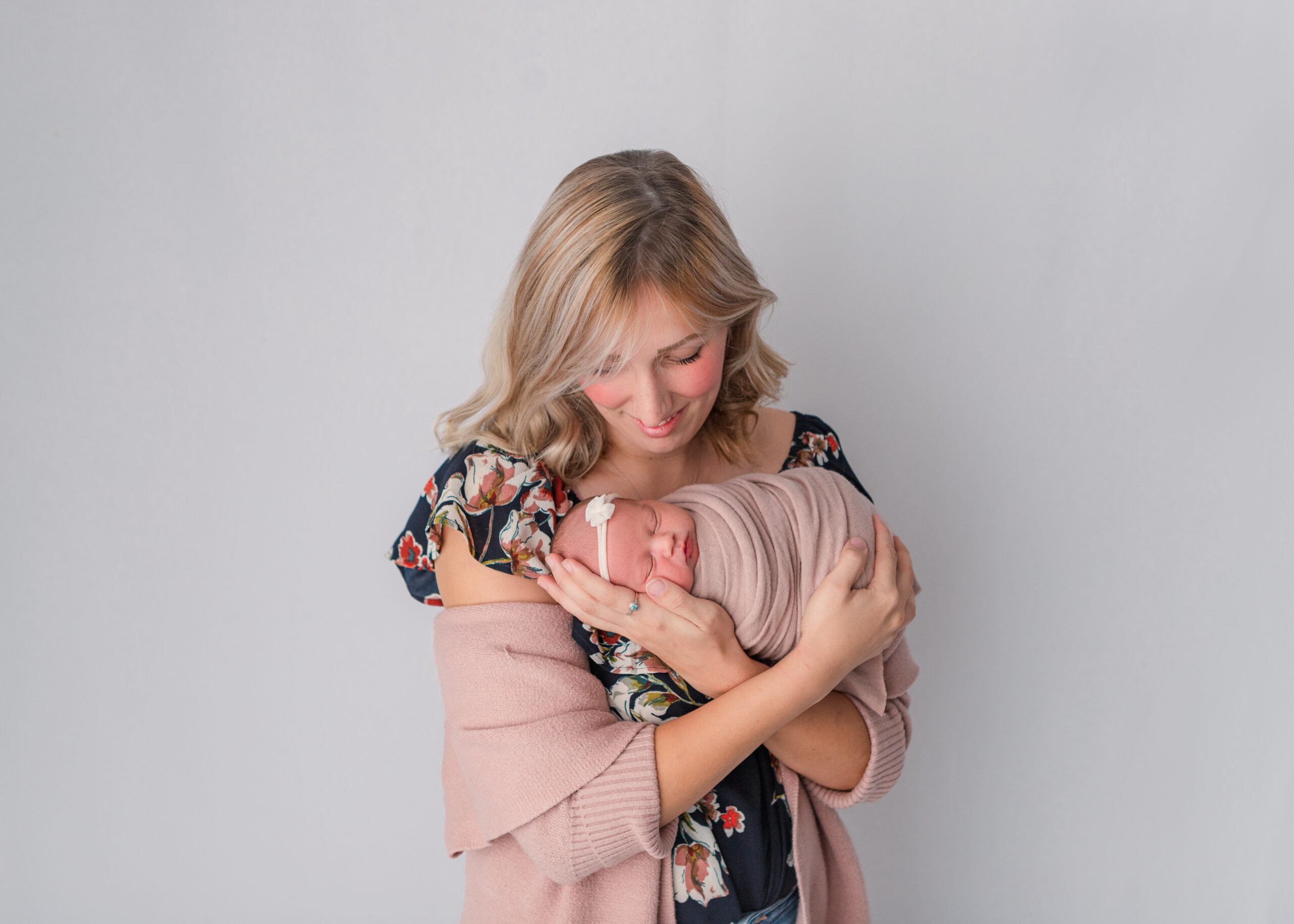 mom with newborn girl wearing floral