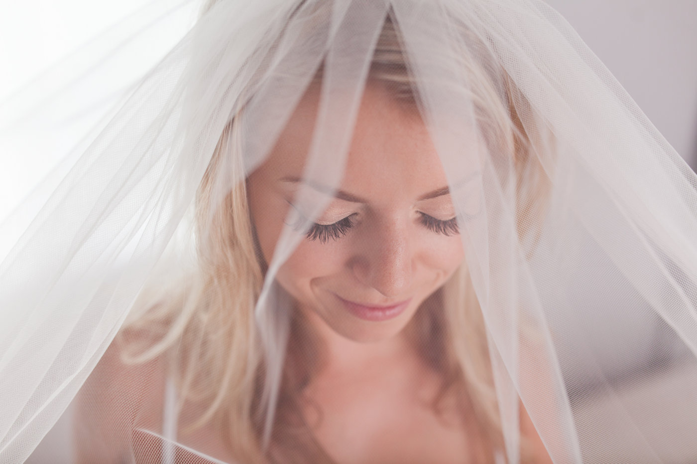 bride wearing veil for boudoir session