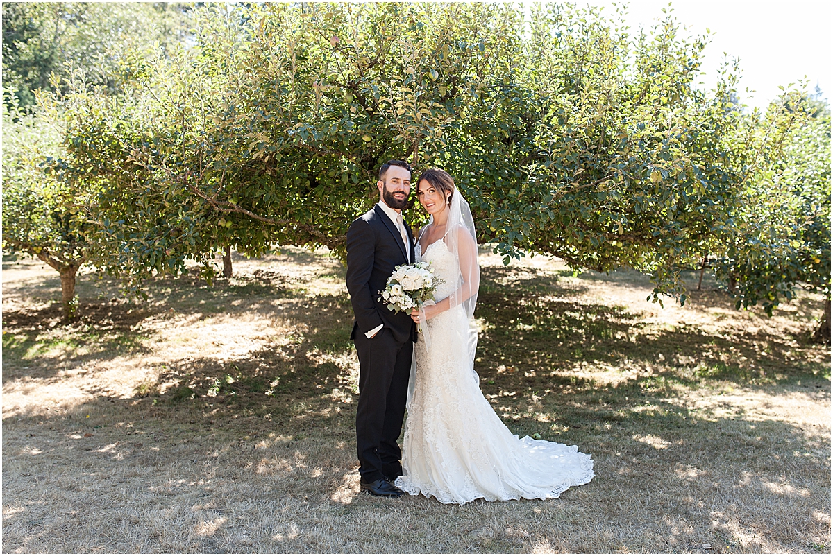 bride and groom at an apple orchard