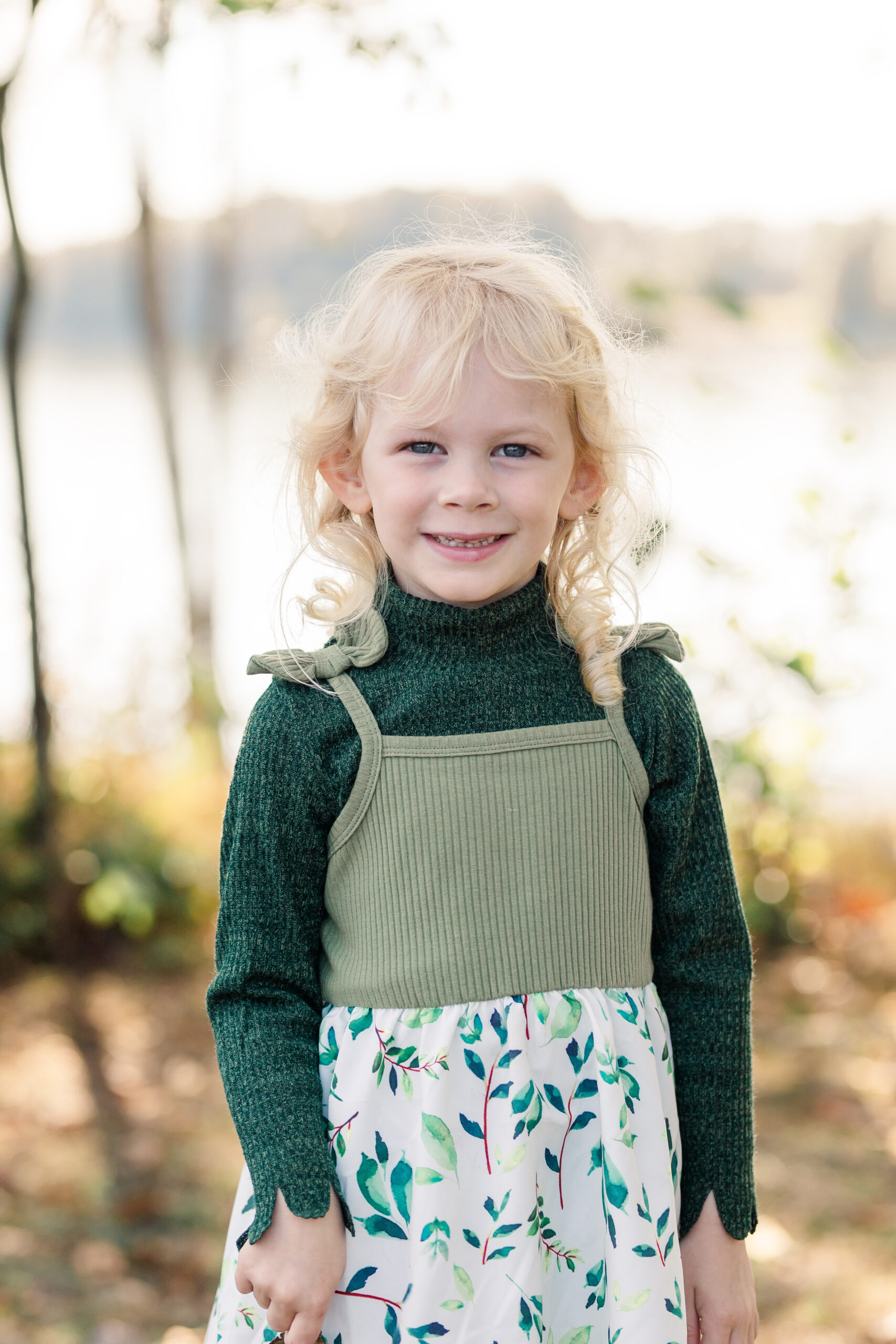 little girl in a green floral dress from Once upon a child kelowna