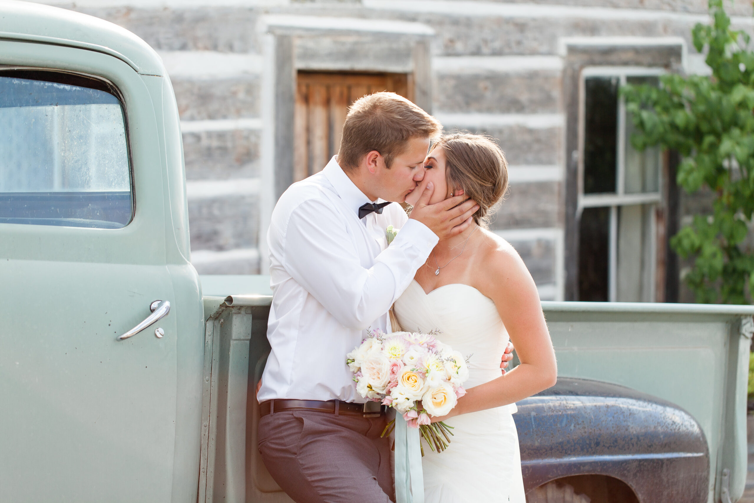 bride and groom share a kiss at a penticton winery wedding venue