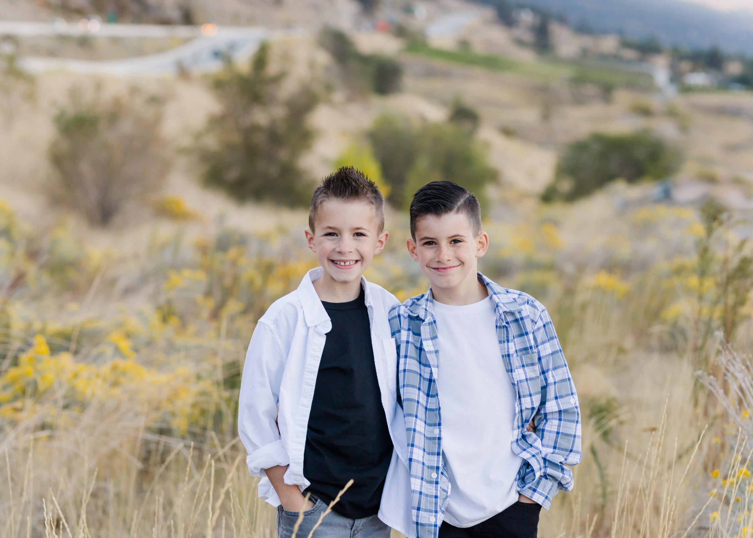 twin boys in kelowna field wearing clothes from childrens place