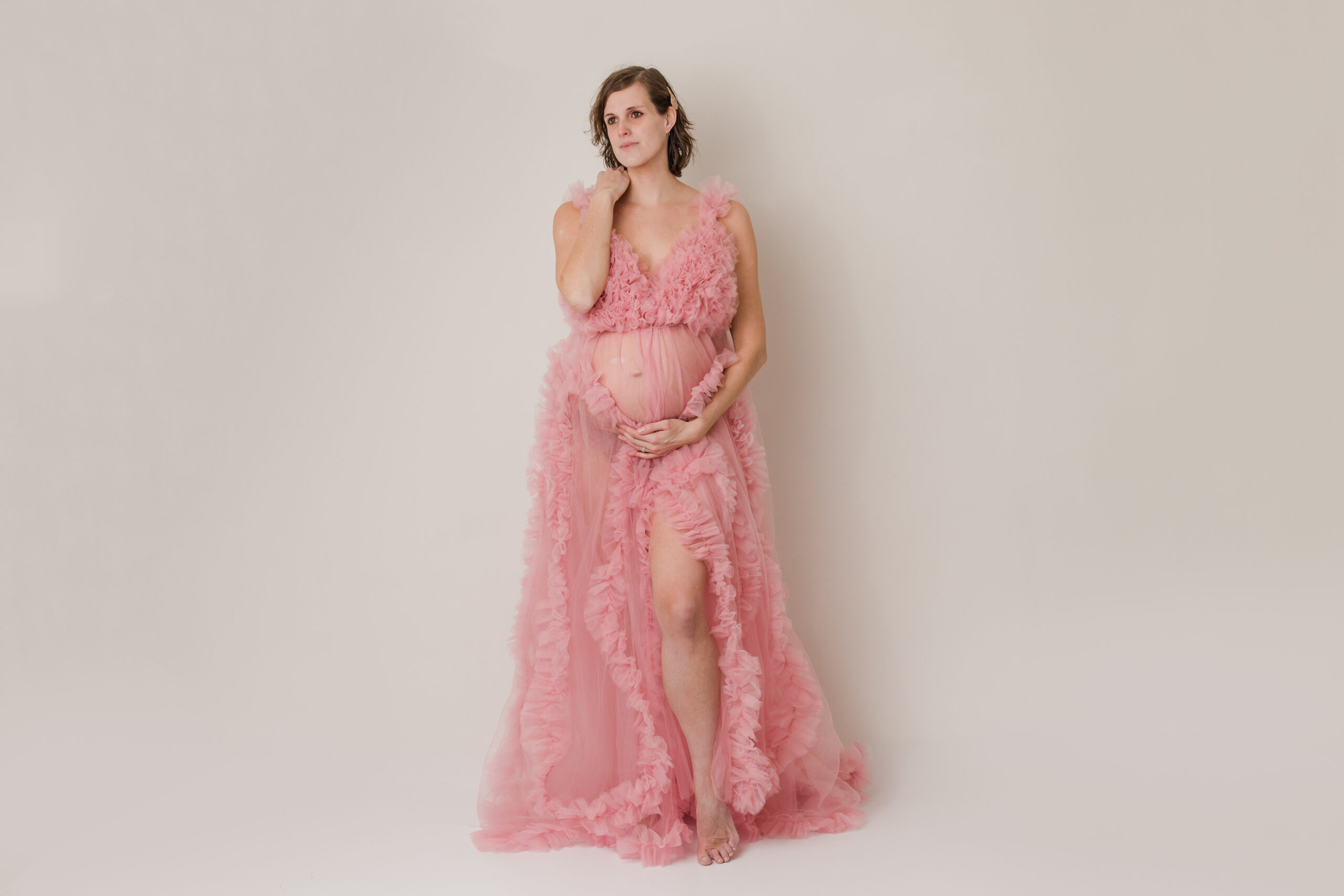 mom to be wearing gorgeous maternity gown